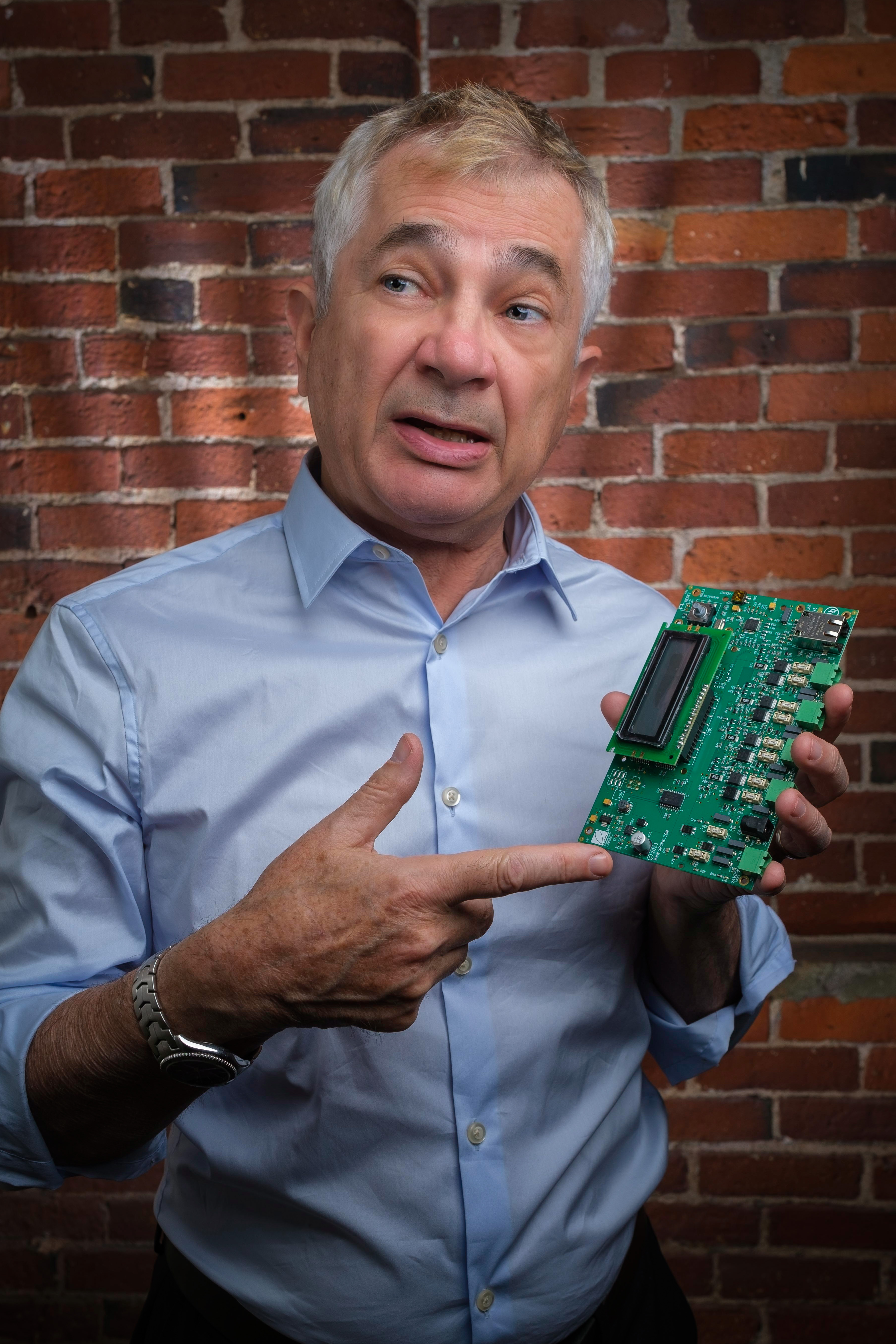 Brian Longwell holding custom PCB board